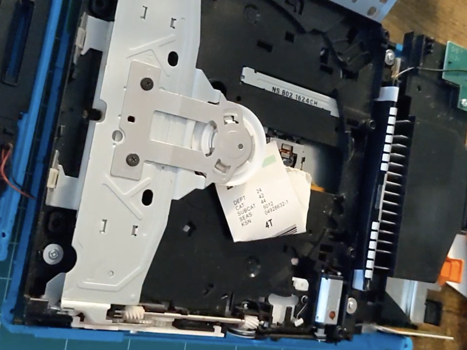 interior of wii disc drive with kmart tag stuck inside